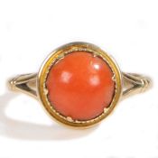 A Victorian 18 carat gold and coral set ring, with a cabochon round cur coral head, ring size M