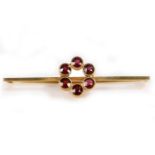 A 9 carat gold and garnet set brooch, with six garnets in a circle to the bar, 3.5 grams, 58mm