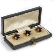 A set of three Edwardian garnet and diamond set studs, square cut garnets with four diamonds to