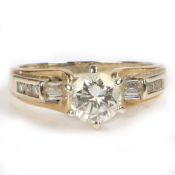 A 14 carat gold diamond solitaire ring, the round cut diamond at approximately 0.8 carats with