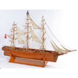 Wooden model of the Cutty Sark, presented on a plinth base, 138cm high, 201cm long
