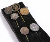 A collection of coin stick/tie pins, each mounted with a coin (6)