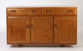 Ercol Windsor three door sideboard. 136cm wide x 82cm high x 46cm deep.