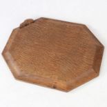 A Robert "Mouseman" Thompson octagonal chopping board, modeled with a mouse to the edge, 30.5cm wide
