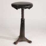 A rare leather upholstered cast iron Singer swivel stool, cast with 'SINGER' to the three feet, 64cm