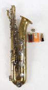A cased Berg Larsen Baritone Saxophone with accessories including three stands and a strap.