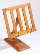 An adjustable oak reading stand marked '"LUMINE" PATENT NO. 20550/11 REG. DESIGN'.