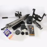 A Lowepro soft carrying case full of camera accessories to include a Velbon tripod, a stand alone