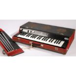 Eko Minstrel electric organ, with red and black case and four detachable legs, 73.5cm wide