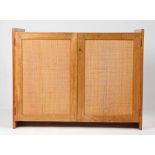 A mid Century teak side cabinet with woven cane work doors. 98cm wide x 75cm high x 51cm deep.