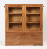 A mid Century teak hanging wall cabinet. 76cm high x 69cm wide x 14cm deep.