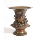 Chinese bronze vase, the flared lip above figures around a large vase and blooming flowers, 15cm