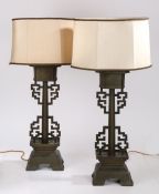 A Pair of Chinese bronze lamps, with a geometric designed arms and an arched base, 56cm high