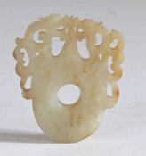 A Chinese jade plaque, Han Dynasty (206 B.C.-220 A.D.) of flattened form, the shoulders carved