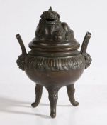 Chinese bronze censer and cover, with a rested temple dog above a circular body and loop handles