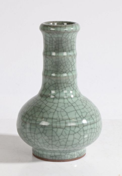 A Chinese crackle glaze porcelain vase, with a long neck and two bands above the squat body and ring