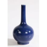 A Chinese monochrome blue porcelain vase, the long neck above a rounded body and ring foot, 19.5cm