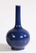 A Chinese monochrome blue porcelain vase, the long neck above a rounded body and ring foot, 19.5cm