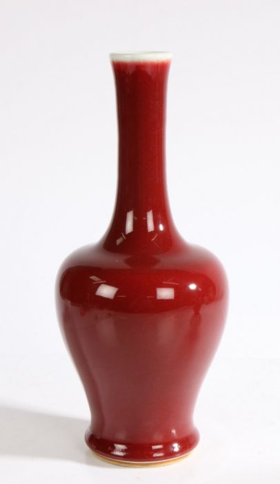 A Chinese copper red porcelain vase, 20th Century, with a celadon lip above a copper red body, six