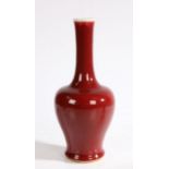 A Chinese copper red porcelain vase, 20th Century, with a celadon lip above a copper red body, six