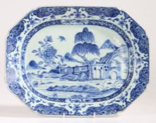 A Chinese porcelain export serving platter, in blue and white decorated with buildings and a tree,