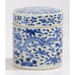 A Chinese porcelain cylindrical box and cover, in blue and white with a dragon among flowers, chip