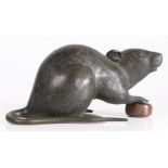 A Japanese Meiji period bronze rat, modelled with front paws on a chestnut, 17cm long, 8.5cm high
