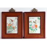 Pair of 20th century Chinese Famille Rose wall plaques, depicting exotic birds perched on a