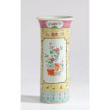 A Chinese famille rose cylindrical vase, the central panels painted with flower filled vases