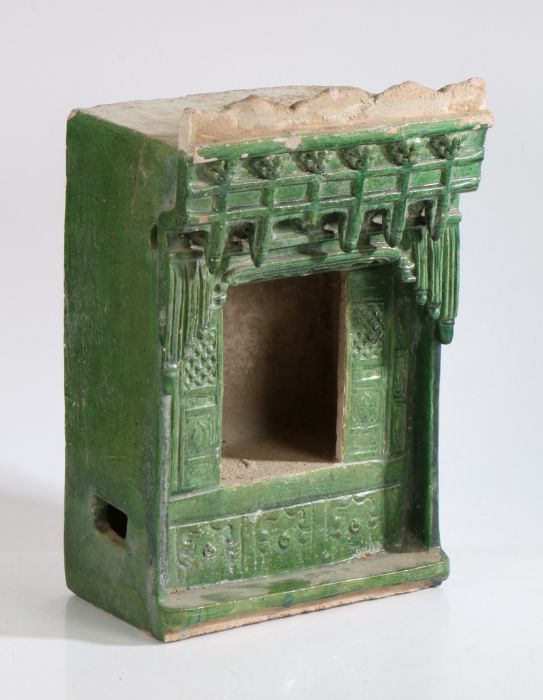 A Chinese stoneware green glazed shrine, late Ming Dynasty, with a gallery above an opening to the