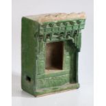 A Chinese stoneware green glazed shrine, late Ming Dynasty, with a gallery above an opening to the