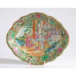 A Chinese 19th Century Canton porcelain dish, decorated with figures in a garden and a foliate and