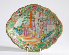 A Chinese 19th Century Canton porcelain dish, decorated with figures in a garden and a foliate and