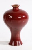 A Chinese meiping monochrome copper red glaze porcelain vase, Qianlong mark but not of the period,