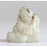A Chinese jade carving of a boy, Qing Dynasty, 17th Century, white tone with black markings,