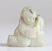 A Chinese jade carving of a boy, Qing Dynasty, 17th Century, white tone with black markings,
