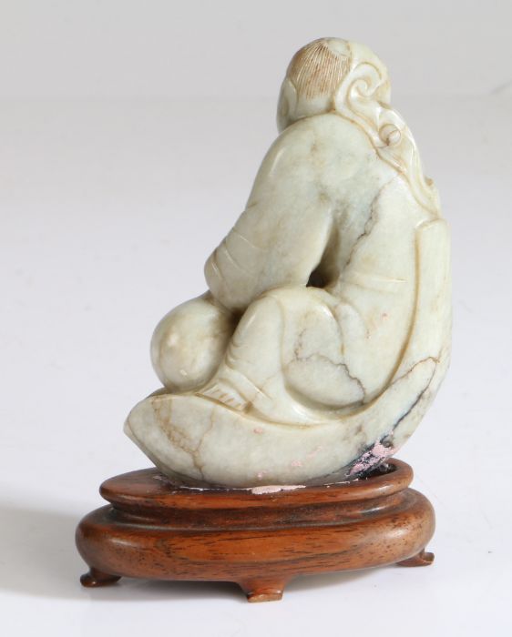 A Chinese jade figure of a boy, Qing Dynasty, 19th Century, carved seat on a lotus leaf petal - Image 2 of 2