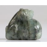 A Chinese jade reclining mythical beast, green and black grained colour, carved into a crouching