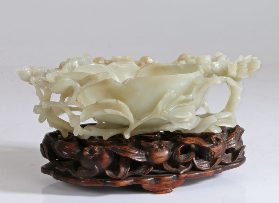 A Chinese jade water coupe, Ming Dynasty (1368-1644) elaborately carved in the form of a large
