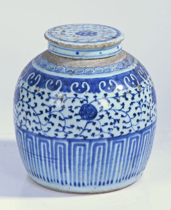 A Chinese porcelain ginger jar and cover, with blue leaf and scroll decoration, geometric base, 21cm