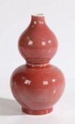 A Chinese double gourd monochrome blush pink porcelain vase, with a small rim above the double gourd