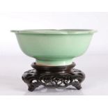 Chinese celadon lotus bowl, the central field with impressed flower head decoration, raised on a