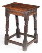 A Charles I oak joint stool, circa 1640 Having an ovolo-moulded top, run-moulded rails, and