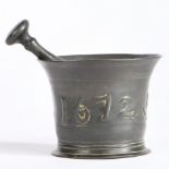 A Charles II bronze alloy mortar and pestle, Suffolk, dated 1672 The flared body cast with the