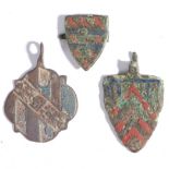 Three 14th century horse harness pendants, English, circa 1350-1400 Each of copper-alloy with red