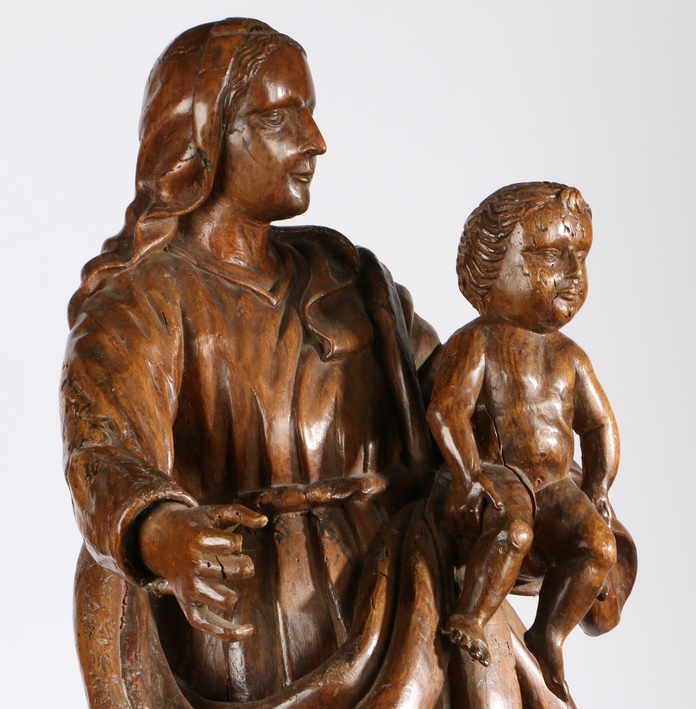 An 18th century walnut figural carving of the Madonna and Child The Virgin wearing flowing robes, - Image 2 of 3