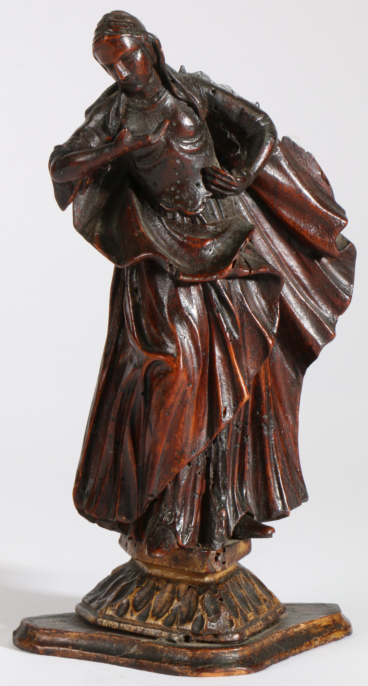 An 18th century limewood figural carving   Female, designed standing, one hand on hip, wearing a