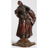 An 18th century limewood figural carving   Female, designed standing, one hand on hip, wearing a