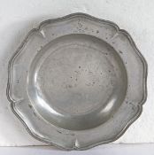 A George III pewter wavy-edge dish, circa 1760 The rim of five lobes, engraved with a stork crest