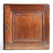 A small William & Mary oak spice cupboard, circa 1700 Having a fielded panelled door, enclosing an